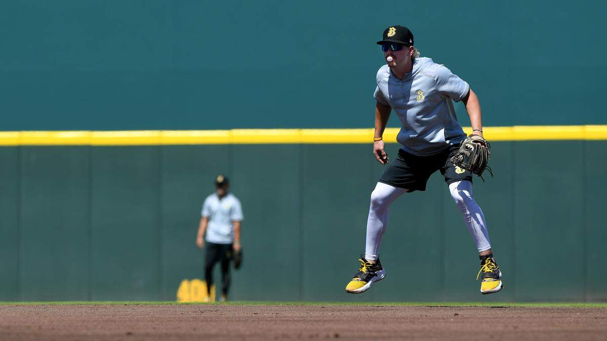 Brenden Dixon, 21 from Texas, jumps and blows a bubble during Tuesday afternoon practice on the field at LECOM before the Bradenton Maurauders’ opening 2022 home game against the Lakeland Flying Tigers.