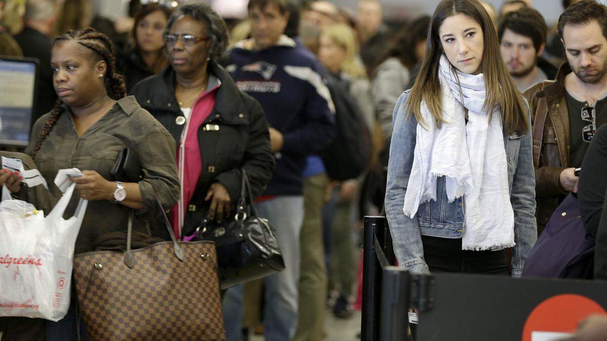 Passengers wait in line to clear security at LaGuardia Airport in New York, Wednesday, Nov. 25, 2015. An expanded version of America's annual Thanksgiving travel saga was under way Wednesday with gas prices low and terrorism fears high. An estimated 46.9 million Americans are expected to take a car, plane, bus or train at least 50 miles from home over the long holiday weekend, according to the motoring organization AAA. That would be an increase of more than 300,000 people over last year, and the most travelers since 2007. (AP Photo/Seth Wenig)