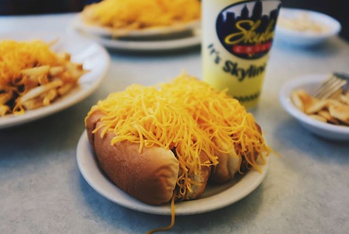 The cheese coney, a specially made hot dog served at Skyline Chili in a steamed bun with mustard and secret recipe chili, topped with onions and shredded cheddar cheese.