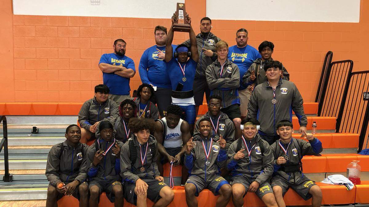 The Bayshore High boys weightlifting team celebrates with their trophy after winning the Class 1A-District 15 championship Friday at Englewood Lemon Bay.