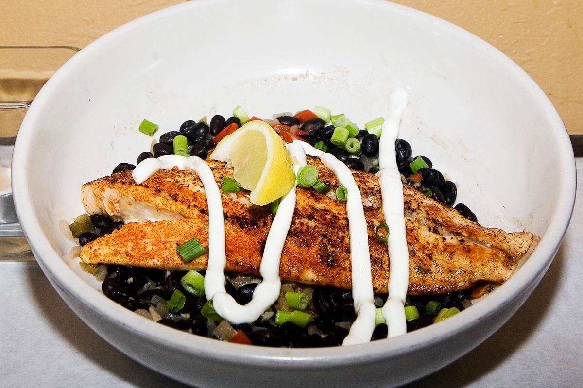 Blackened redfish served with black beans and rice is one of the seafood offerings at Mean Deans Local Kitchen, 6059 26th St. W., Bradenton. The neighborhood restaurant opened Nov. 17. The owner is veteran restaurateur Dean Donnelly.