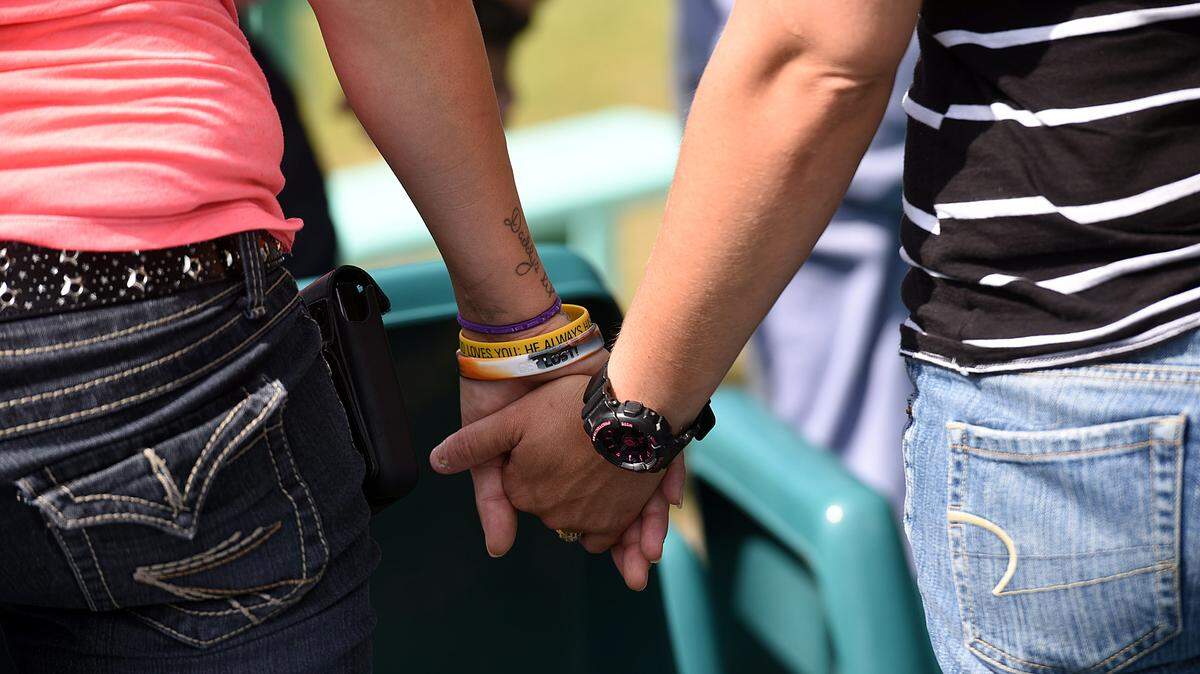 Inmates at Bradenton Bridges, a women-only transition facility, hold hands during a press conference to try to keep the facility's doors open after the state of Florida did not extend the contract with the facility. 
 TIFFANY TOMPKINS/Bradenton Herald