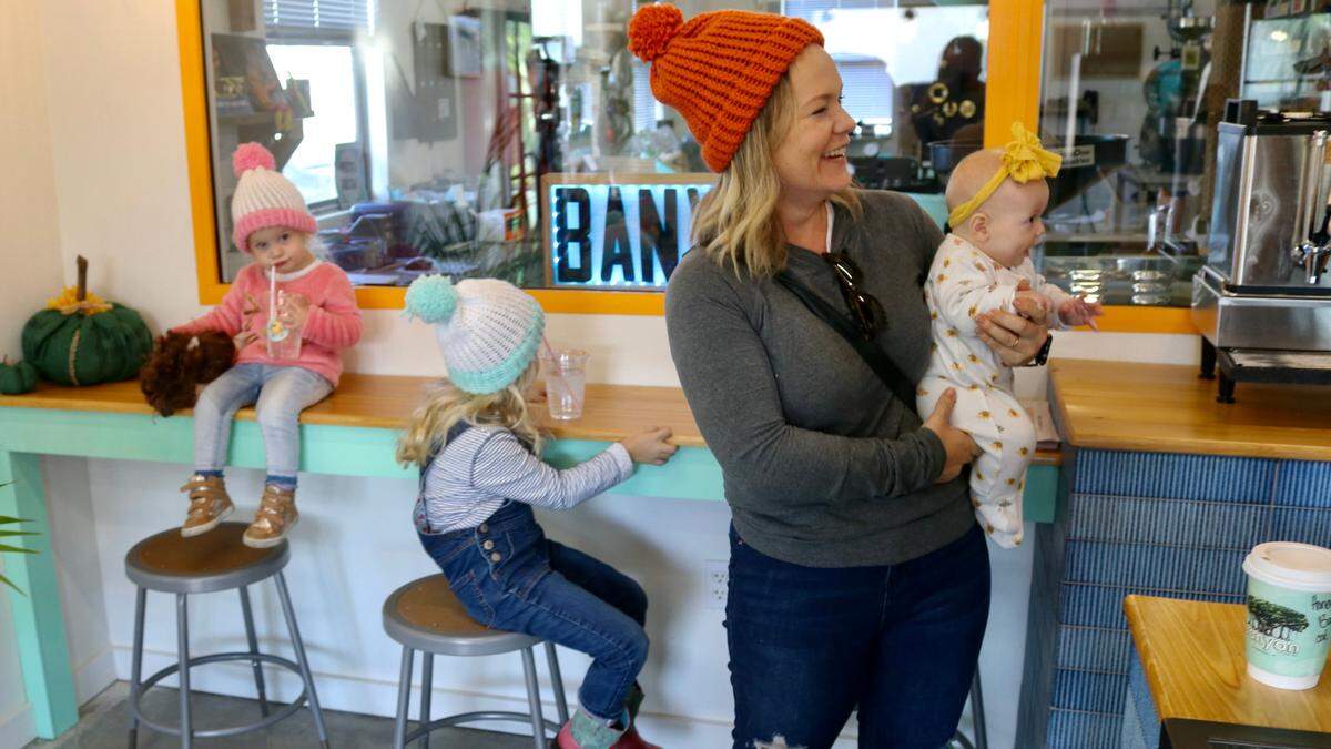 Rachel Berube came to Banyan Coffee Company in Palmetto on Nov. 18, 2022, with her daughters, from left, Maggie, 2, Rosie, 5, and Juniper Jane, three months.