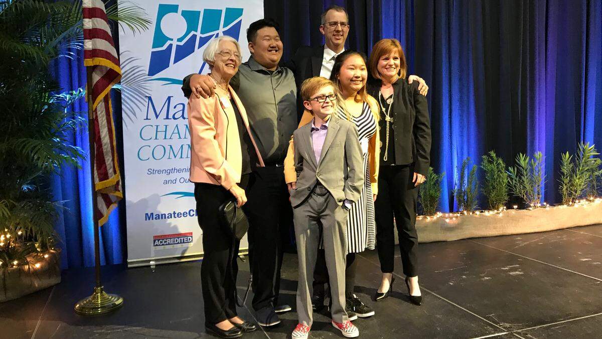 The Poulton family gathered on stage at the Bradenton Area Convention Center after Bill Poulton was installed as chairman of the board of the Manatee Chamber of Commerce on Thursday. Shown above, from left, are Ginny, Jack, Tyler, Bill, Emily and Tara Poulton.