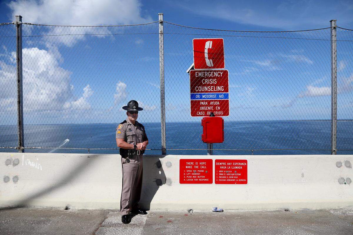 Florida Highway Patrol Sergeant Steve Gaskins stands at the peak on the southbound easement of the Sunshine Skyway Bridge on Wednesday, July 21, 2021, in St. Petersburg, where the new suicide prevention barrier has been completed.
