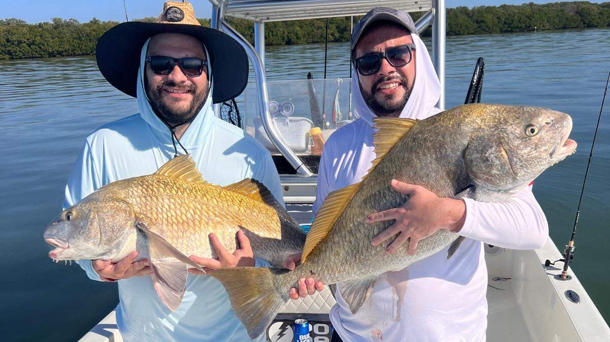 Katchesco Calavetti (right) with black drum caught fishing with Capt. Brett Norris in Tampa Bay.