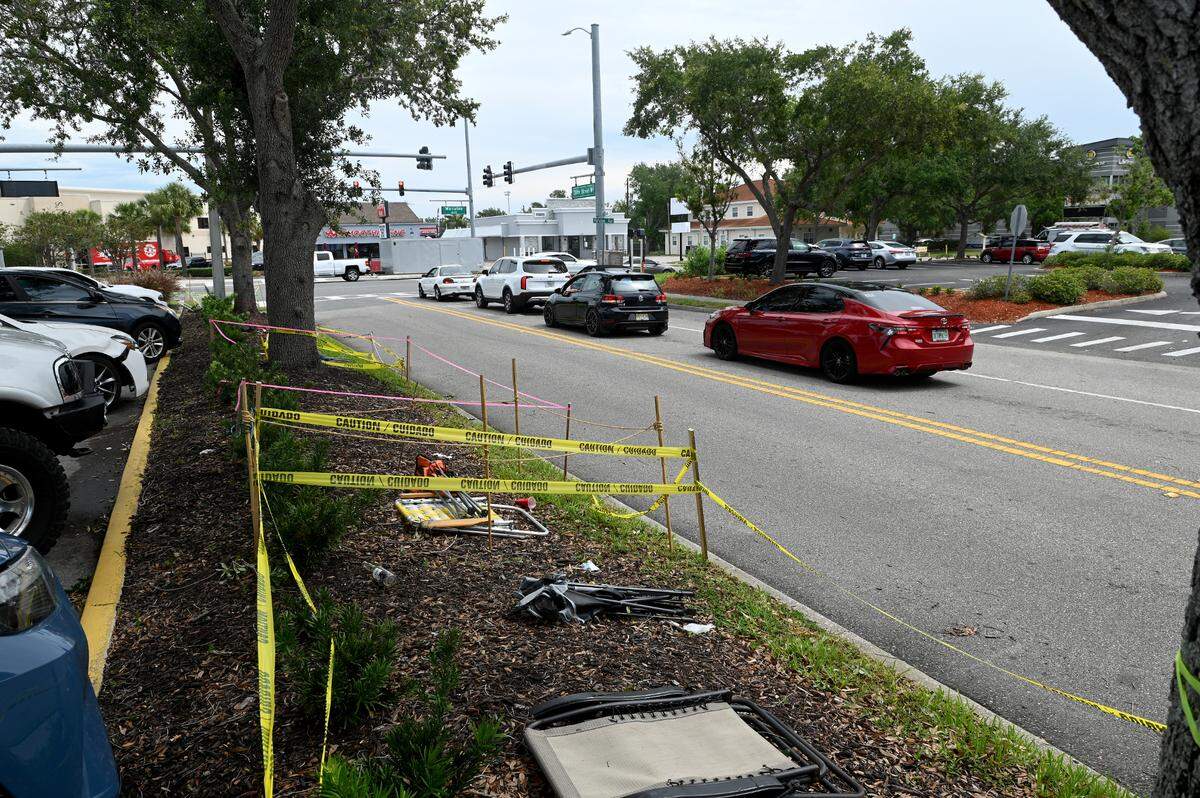 A couple of folded chairs and caution tape outline someone’s ‘reserved’ spot to view the De Soto Parade on 39th Street West.