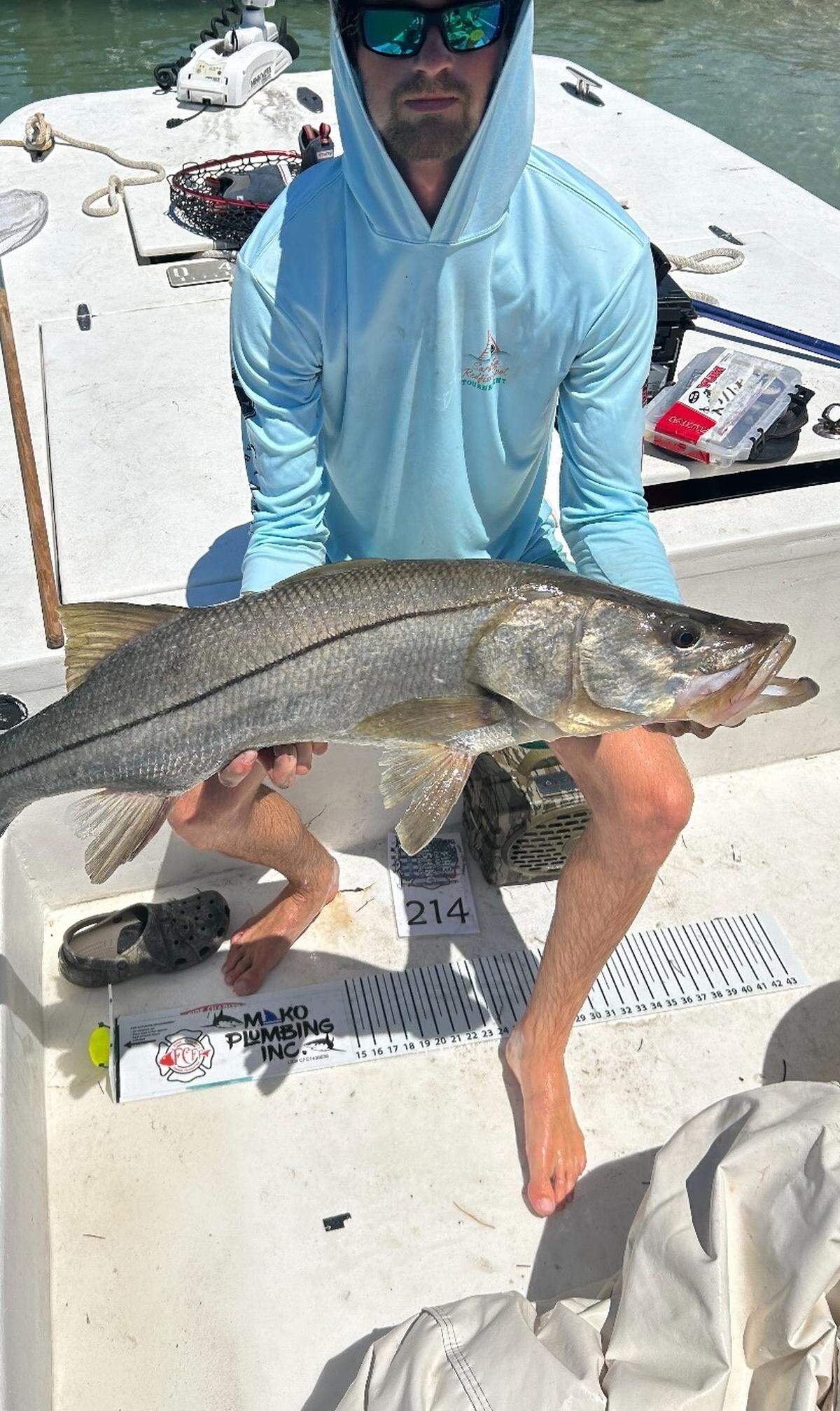 A member of Team Hurricane Fishing poses with one of the four snook they caught to take home the first-place prize in the Big Art Memorial Snook fishing tournament.
