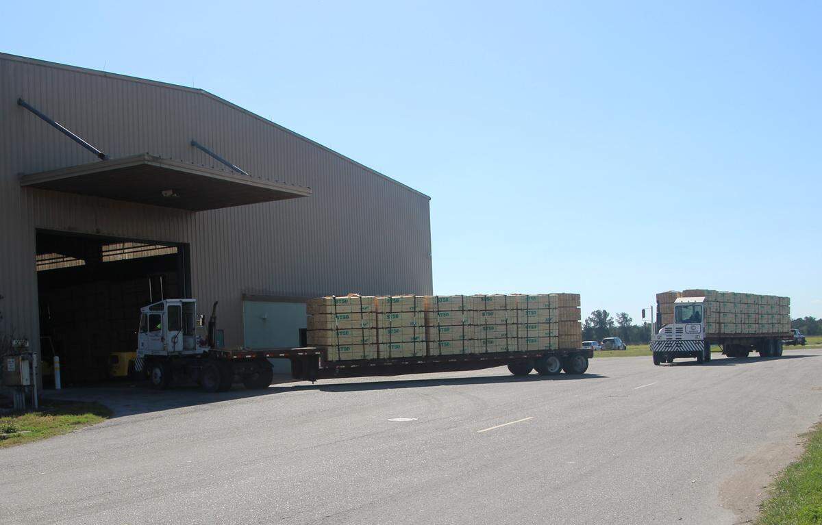 Flatbed trucks were haul tons of imported lumber and other cargo from ships to a warehouse at Port Manatee.