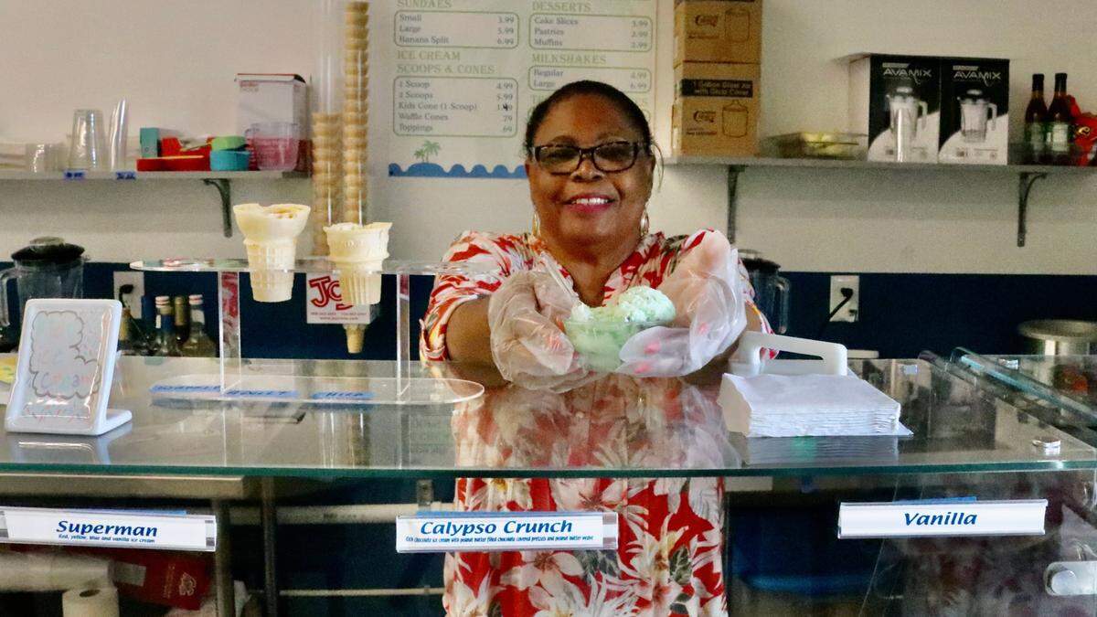 Mildred Golden, shown Sept. 12, 2022, serving a bowl of mint chocolate yogurt, is happy to have Millie’s Sweets and Treats open on Bradenton’s Old Main Street. It’s the latest business to open in the City Centre building.