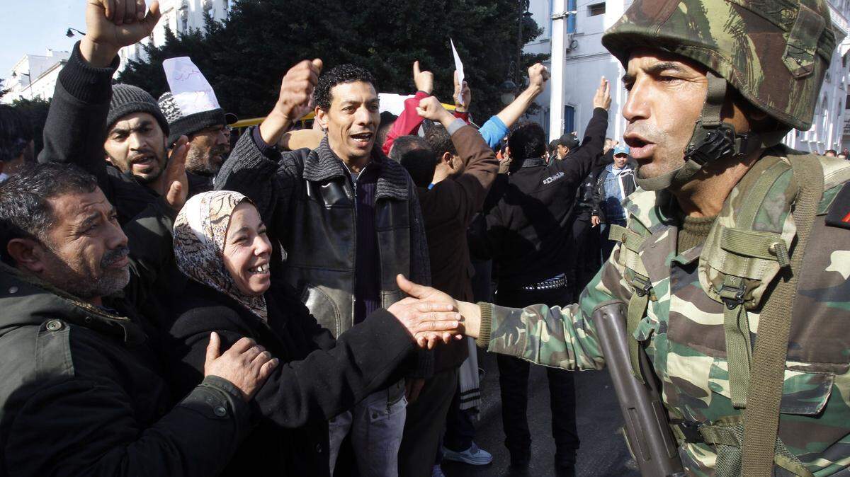FILE - In this Monday, Jan. 17. 2011 file photo protestors greet soldiers during a demonstration against former Tunisian President Zine El Abidine Ben Ali in the center of Tunis. A Tunisian democracy group won the Nobel Peace Prize on Friday Oct. 9, 2015 for its contributions to the first and most successful Arab Spring movement. The Norwegian Nobel Committee cited the Tunisian National Dialogue Quartet "for its decisive contribution to the building of a pluralistic democracy" in the North African country following its 2011 revolution. (AP Photo/Christophe Ena, File)