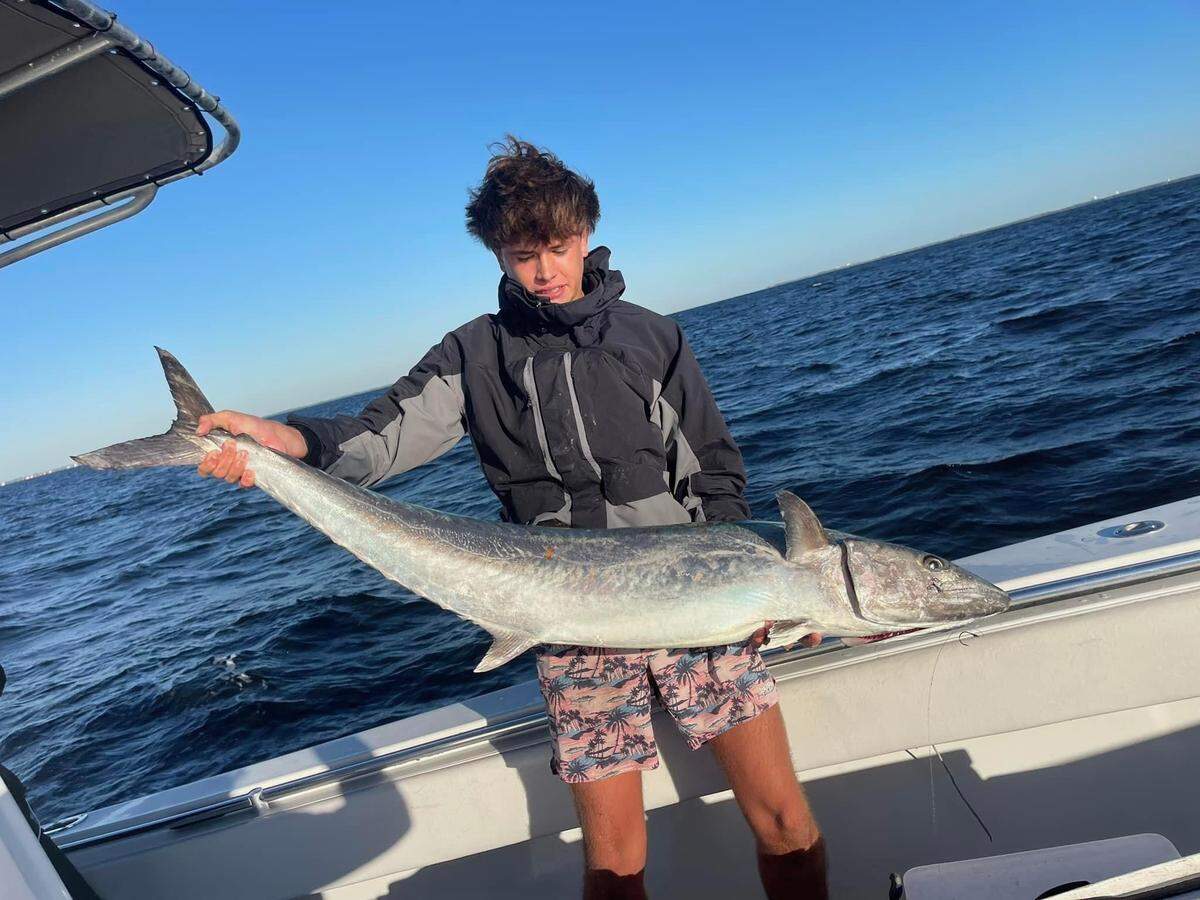 Luke Ramalho poses with the 43.79-pound kingfish that secured Team 99 Problems a third King of Beach Tournament victory in Tampa Bay.