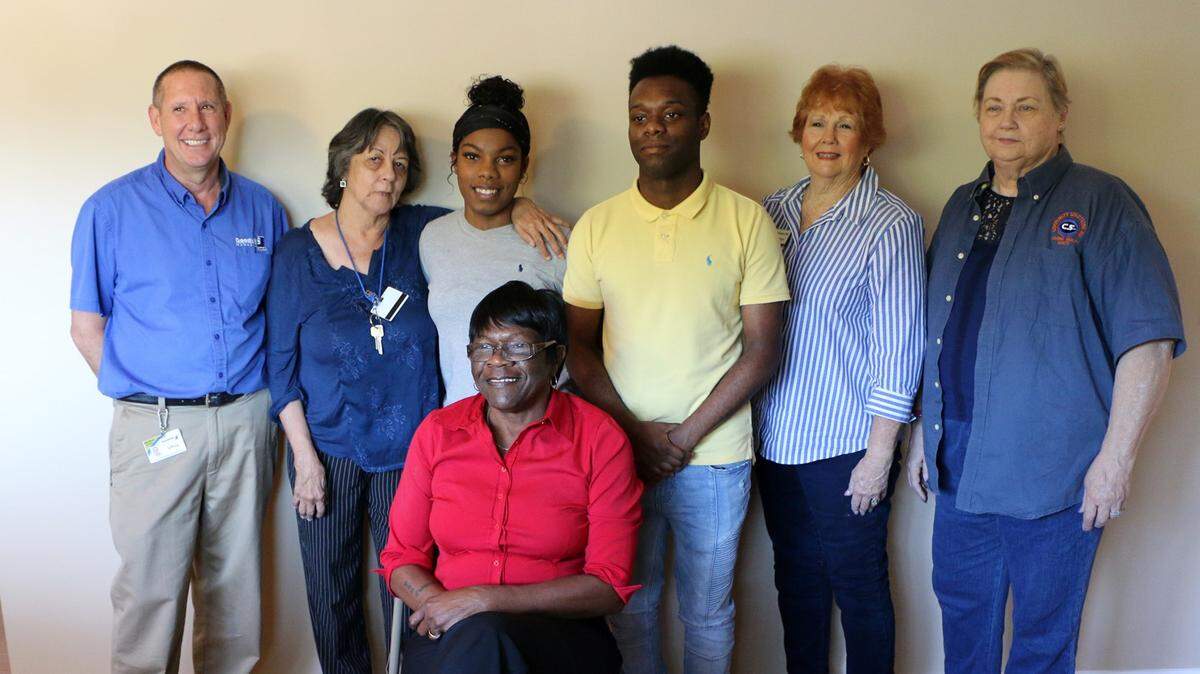 In attendance during Mimi Williams’ (front, seated) move into her new home were, from left, Goodwill Mecca store manager Jeff Motchok, GoodPartner Coach Diana Olivieri, Mimi’s grandchildren Okera and Brenden Brewster, and Laura Carter and Nancy Crawford of Community Solutions 360
