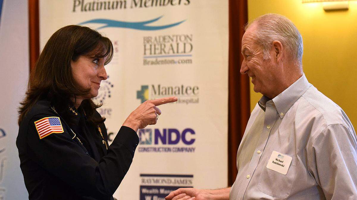 Newly appointed Bradenton Police Chief Melanie Bevan shares a conversation with former Chief Michael Radzilowski at a VIP luncheon honoring both chiefs hosted by the Manatee Chamber of Commerce. 
 TIFFANY TOMPKINS/Bradenton Herald