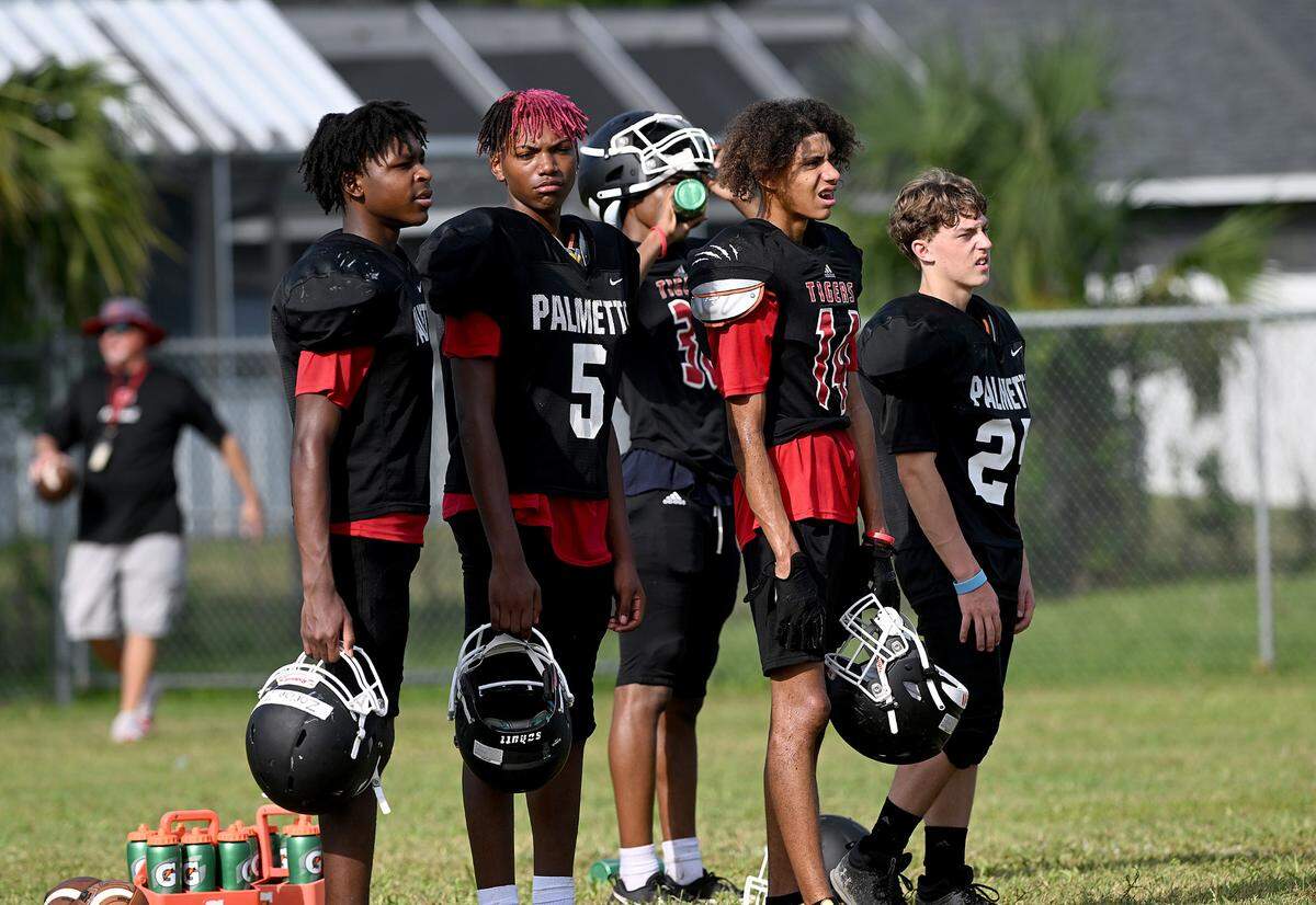 The Palmetto High football team practice at the Palmetto Charter School in the morning to try to beat the heat of the afternoons.