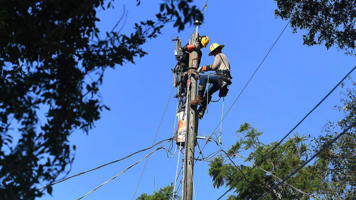 MasTec linemen, one who said they were from Pensacola, work on power lines in West Bradenton on October 3, 2022 after Hurricane Ian left thousands in Manatee County without power.