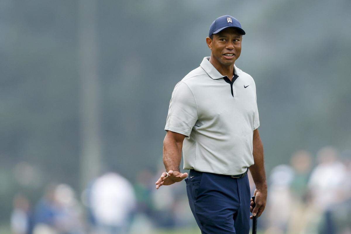 Tiger Woods reacts to patrons on the third green during the practice round for the 2023 Masters Tournament at Augusta National Golf.