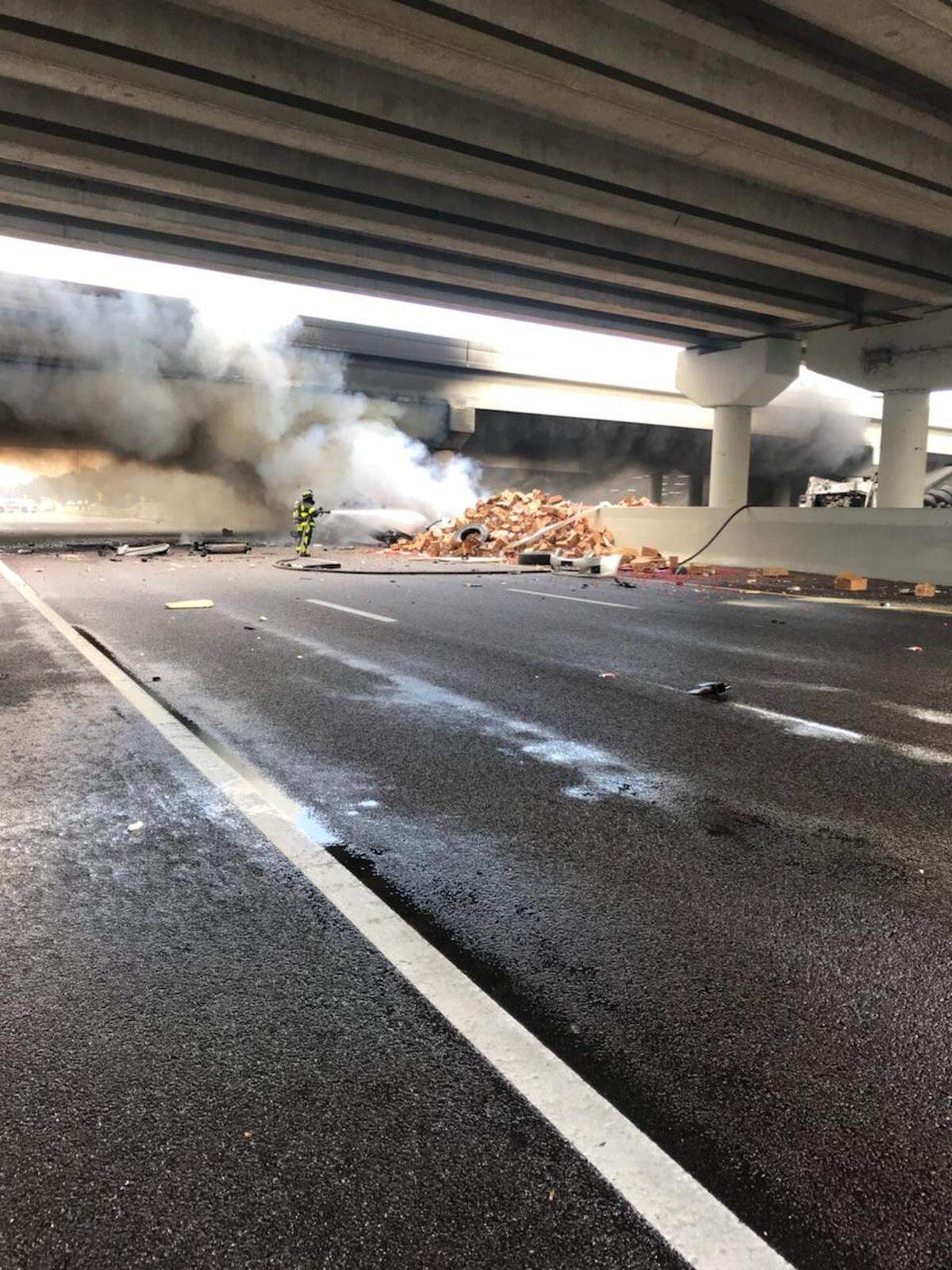 At least one person is dead and Interstate 75 in completely shut down in Hillsborough County after the driver of a tractor trailer carrying produce lost control, went through the guard rail and landed below on top of at least one car on Fowler Avenue killing a person inside.