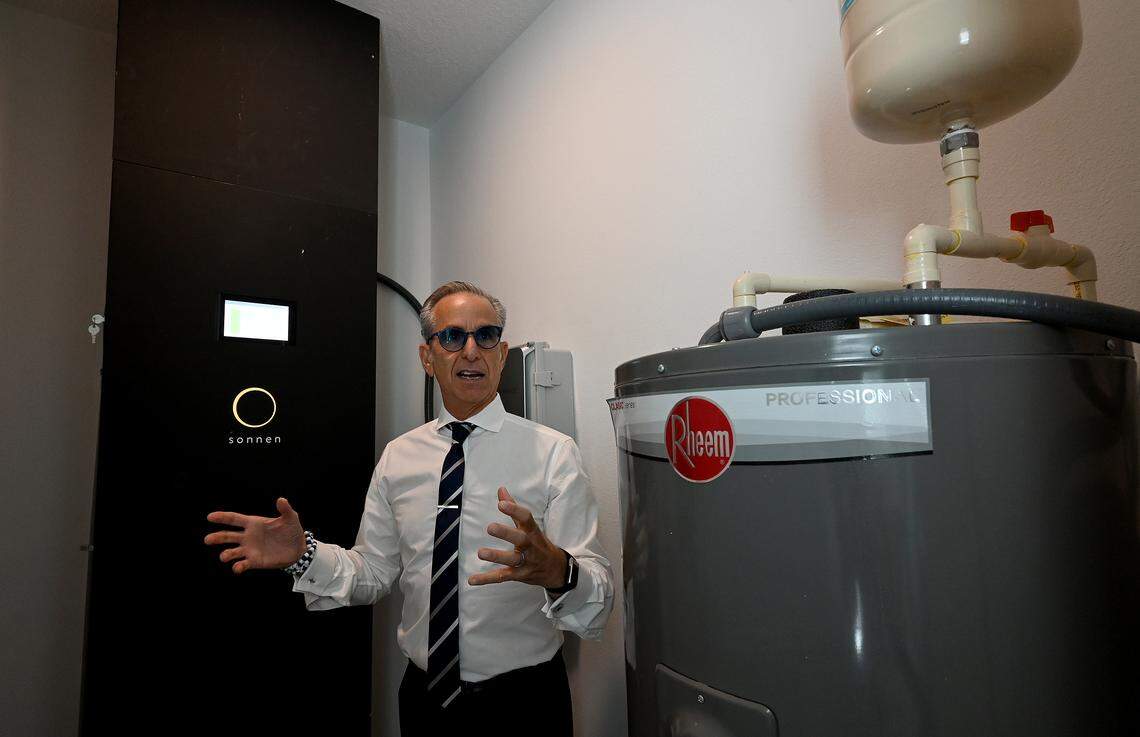 Marshall Gobuty, founder and president of Pearl Homes, explains the battery system that stores the solar energy collected by solar panels on the roof. Hunters Point is a first-of-its-kind development in Manatee County that combines net-zero energy use with resiliency to hurricanes, flooding and harsh weather. Photo taken on Oct. 8, 2025.