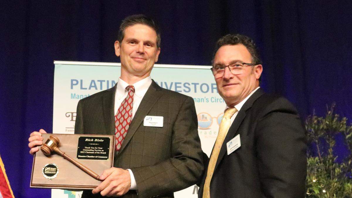 Rick Bisio, left, accepted a plaque as outgoing chairman of the Manatee Chamber of Commerce from incoming chair Jeff Podobnik, the senior director of Florida and Dominican Republic operations for the Pittsburgh Pirates, Thursday night (Feb. 2, 2023) during the chamber’s 60th annual dinner.