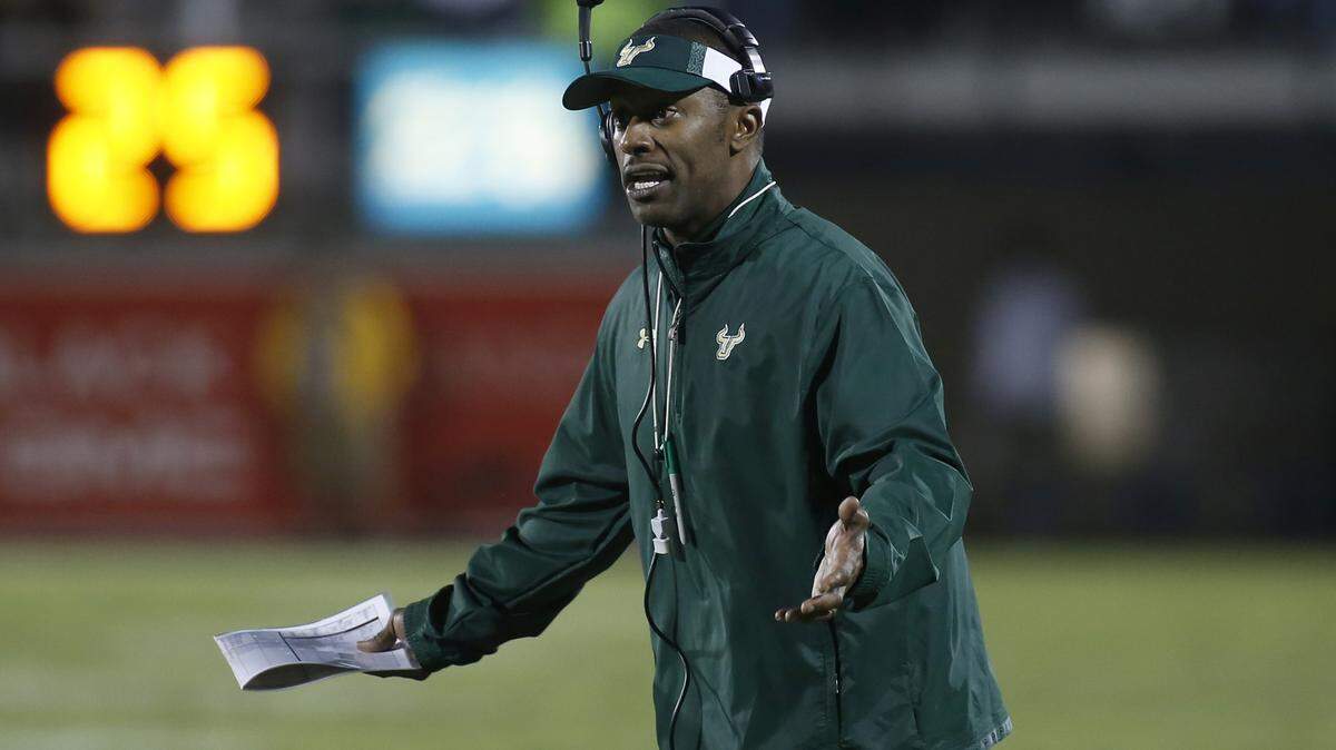 Bowl-bound USF head coach Willie Taggart. shown leading the Bulls on Nov. 29, 2013, against UCF in Orlando, has a big number -- 11 -- of records set during his playing days with the Western Kentucky Hilltoppers. ASSOCIATED PRESS FILE PHOTO