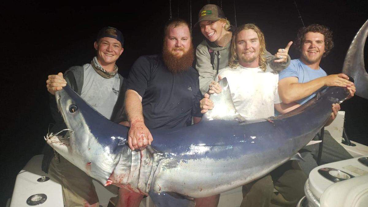 From left: Garrison Clark, Austin Martin, Jessica Kroke, Kyle Cherko and Jeremy Fournier with a mako shark.