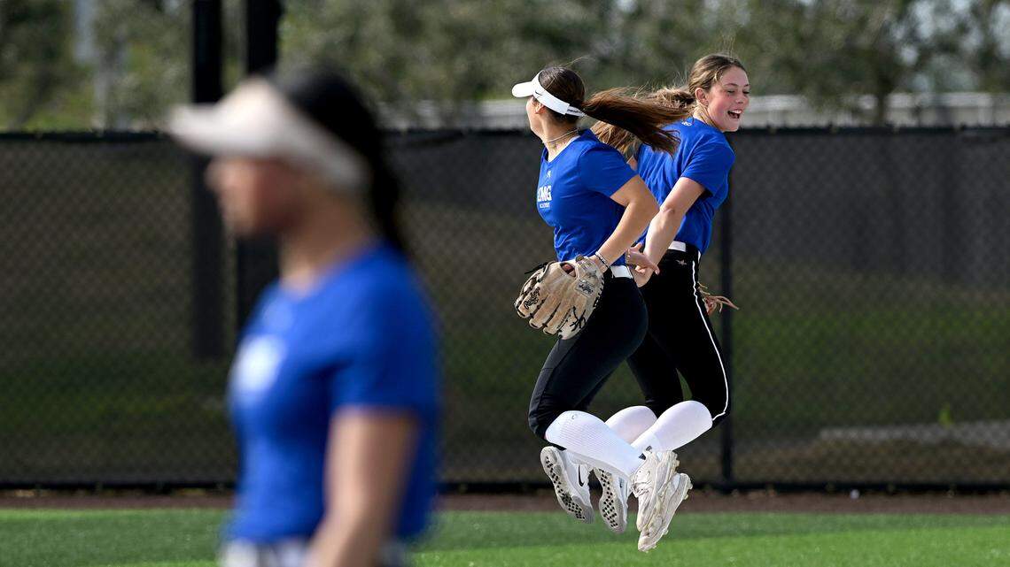 Bree McHughes, right, celebrates a catch with another prospect at IMG’s new softball facilities on Softball Prospect Day.