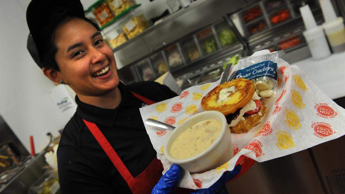 Genesis holds a Blueberry Blue grilled donut with pepperoni pizza soup at Tom+Chee, a new restaurant at 5231 University Parkway that specializes in grilled cheese sandwiches and tomato soup. 
 GRANT JEFFERIES/Bradenton Herald