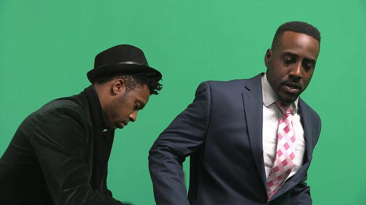 Director Bryan Boykins, left, gets Troy Williams ready for a take on set of "The Watchman's Edict."