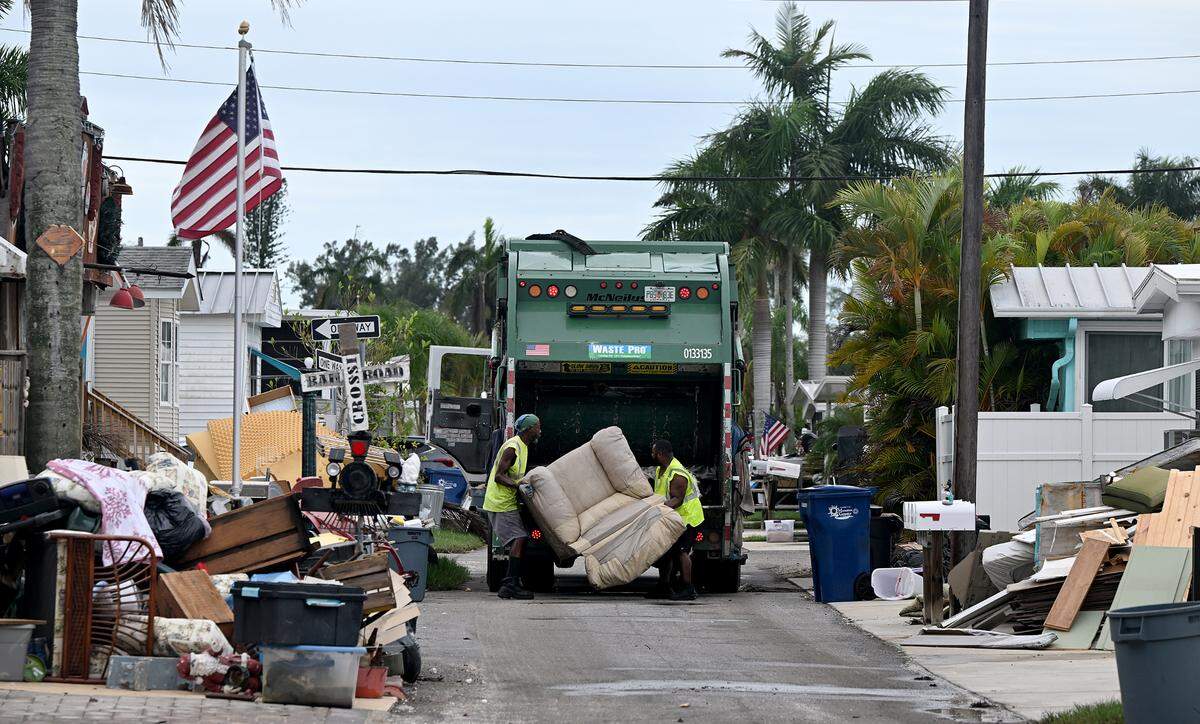 Waste Pro workers load debris left from Hurricane Helene in Sunny Shores as Hurricane Milton approaches Manatee County on Oct. 8, 2024.
