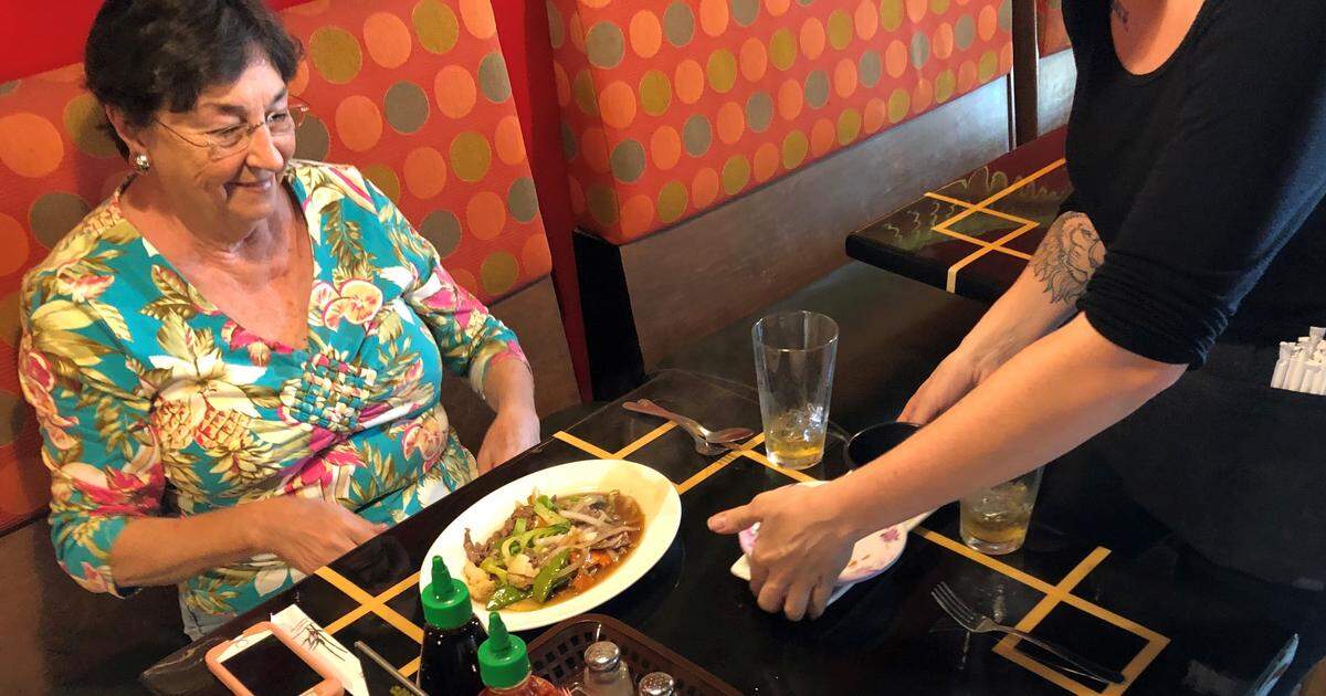 A diner prepares to dig into a plate of beef stir fry at Demi’s Noodle House. The restaurant is located at 1318 10th St W, Palmetto.
