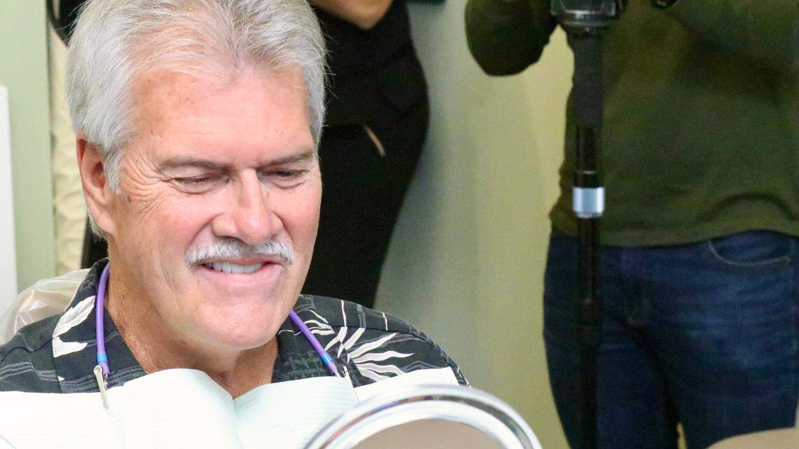 Tim Munford, a disabled Bradenton veteran, takes a look at his new dental implants for the first time on Friday. The smile makeover, valued at $50,000, was a gift from Rubino Periodontics and Implant Dentistry.