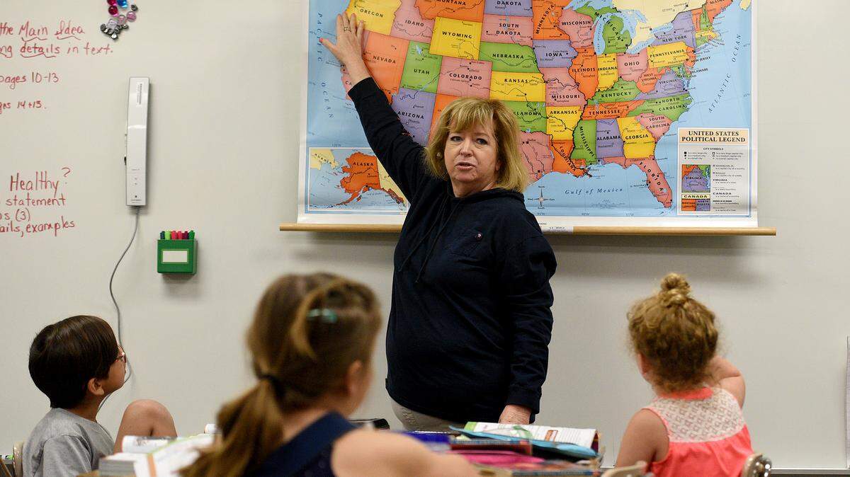 Fourth grade teacher Kim Nicholas goes over a map with students at Jessie P. Miller Elementary School.