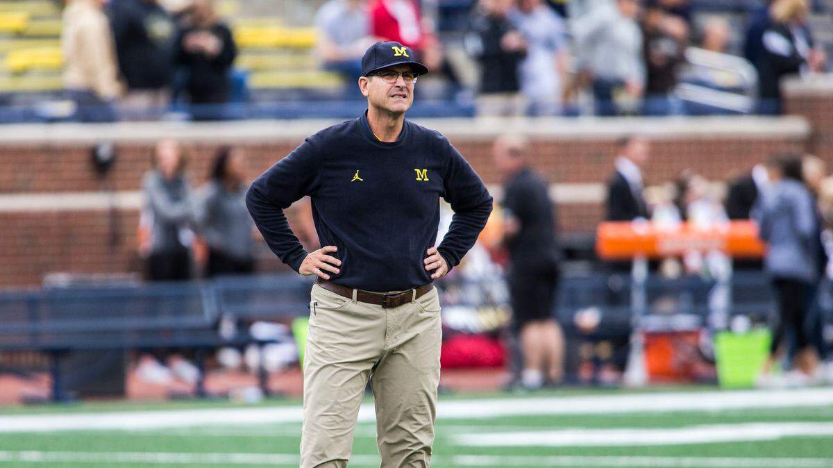 Michigan head coach Jim Harbaugh watches his team warmup on the Michigan Stadium field before an NCAA college football game against Western Michigan in Ann Arbor, Mich., Saturday, Sept. 8, 2018.