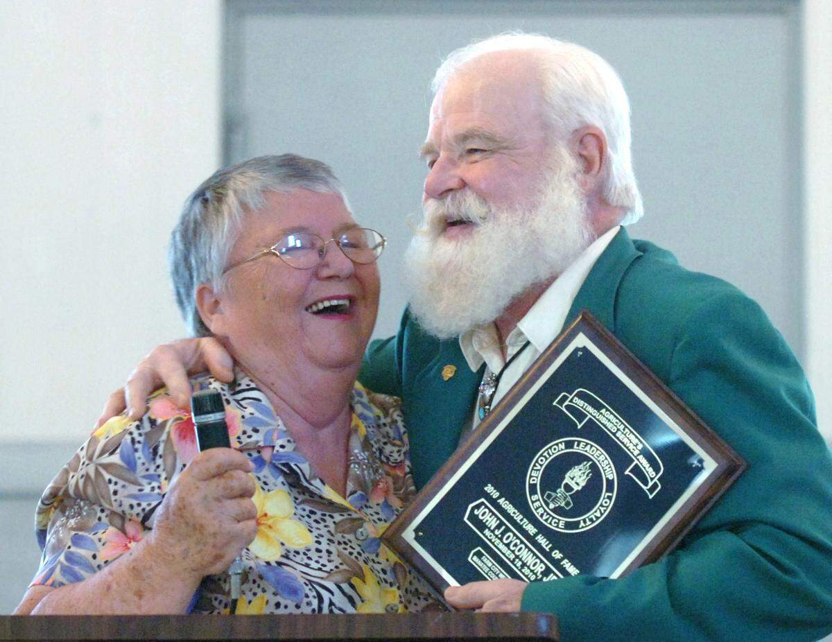 Betty Glassburn is hugged after introducing Manatee County Agriculture Hall of Fame inductee John O’Connor at the Farm City Week 2010 Hall of Fame luncheon.