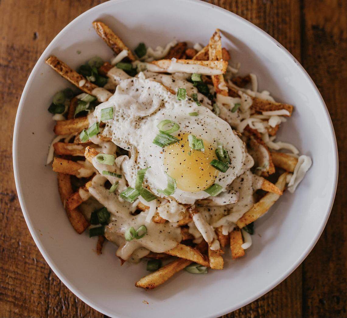 France​ Fries (fries topped with a sunnyside fried egg, black-pepper cognac cream, and Fontina cheese) are offered for $8 at Food + Beer, 4808 14th St. W., Bradenton.