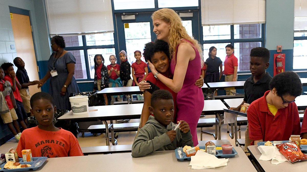 File photo -- 10/03/2019 Manatee Elementary School Principal Tami VanOverbeke gets a hug from a student in the cafeteria. She is one of several principals to assume new jobs in the 2021-22 school year.