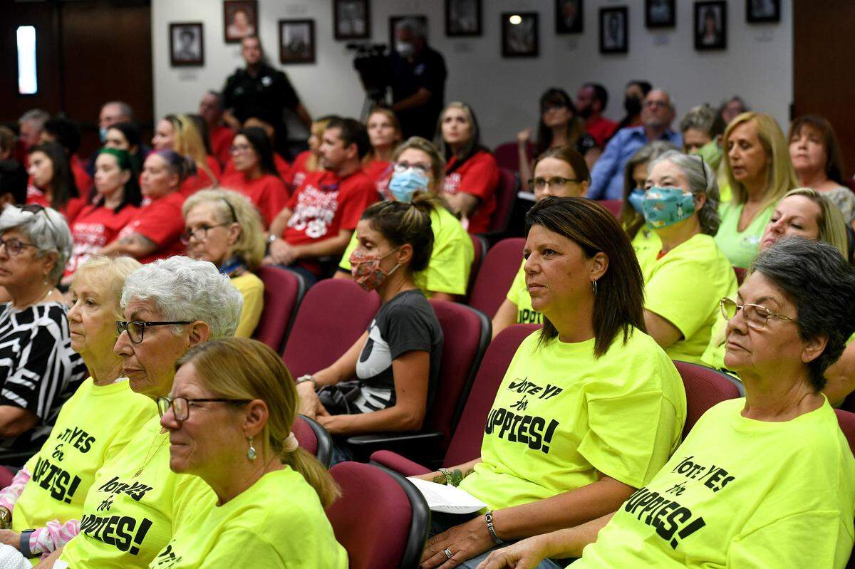 Advocates for pet retailers wore red shirts and those for a ban on selling cats and dogs at retailers wore neon yellow during an August 2021 public meeting when the Manatee County Commission voted to ban the retail sale of cats and dogs.