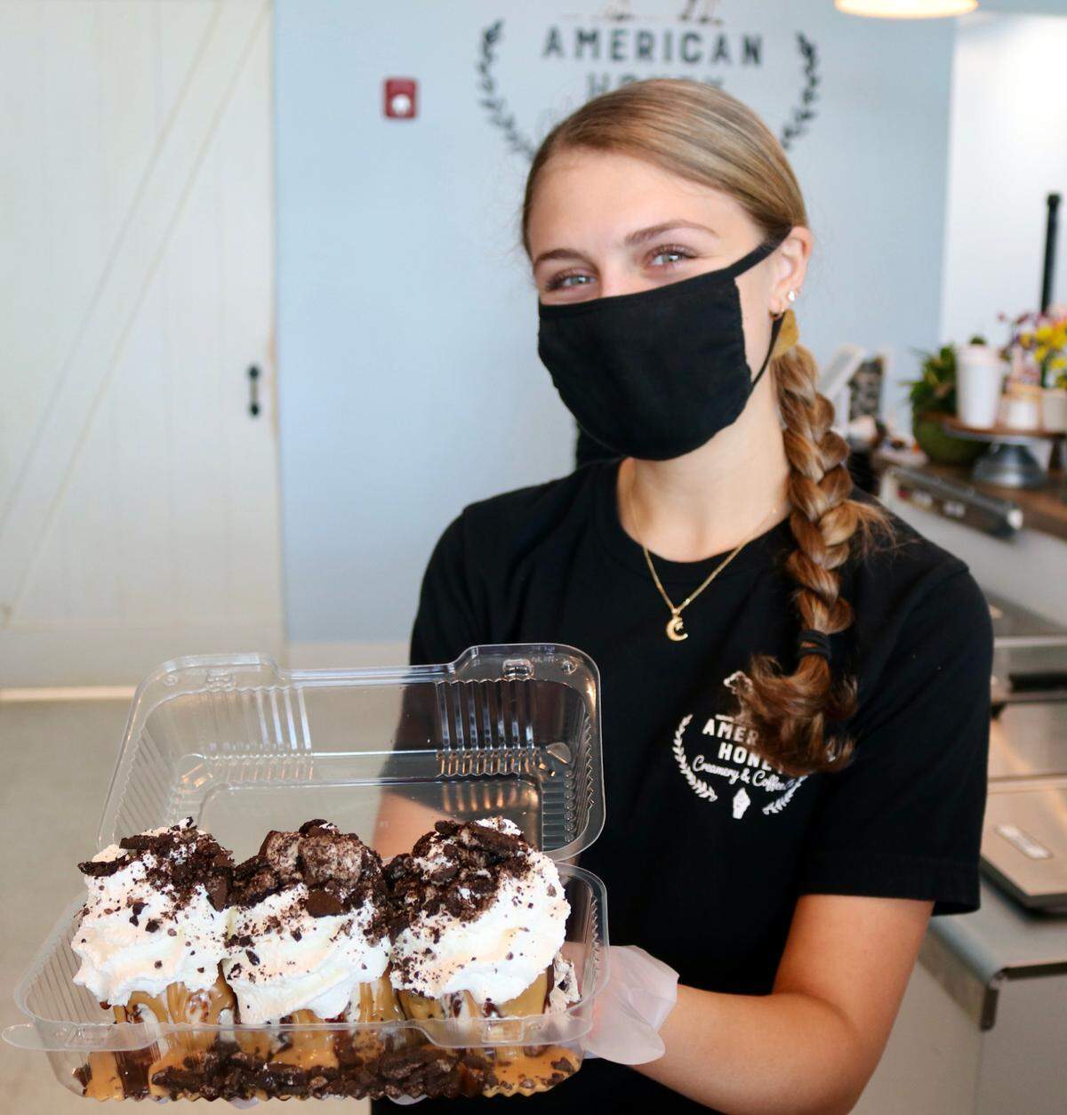 5/19/2021--Lia Kitchens holds a freshly made Holy Heifer sundae at American Honey Creamery, located at 4949 96th St. E., Palmetto, on the southwest corner of Interstate 75 and Moccasin Wallow Road.