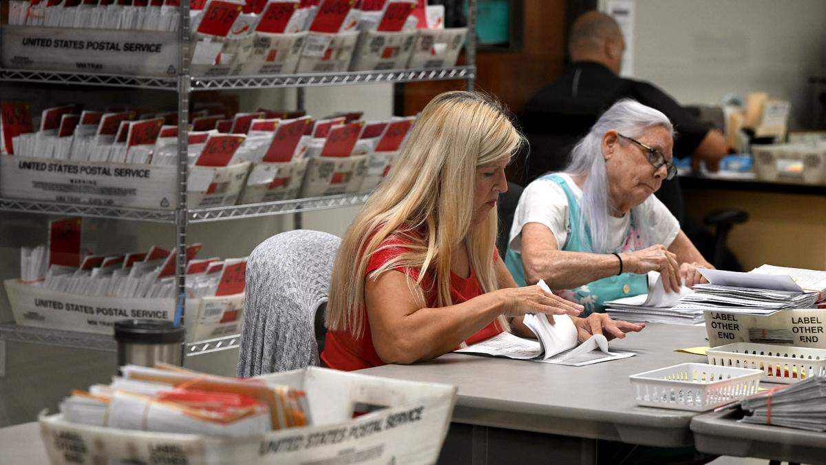 Workers sort mail-in ballots at the Manatee County Supervisor of Elections Office on Nov. 5, 2024.