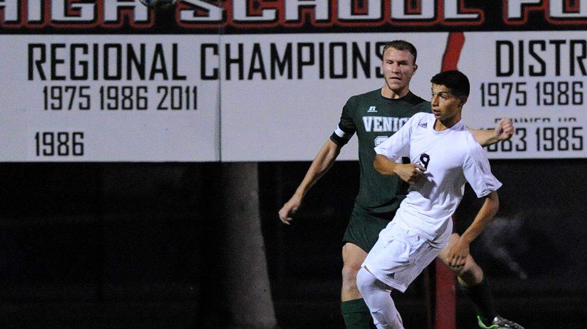 Palmetto's Ben Espinal keeps and Venice's John Gokey vie for the ball in the district 4A-11 semifinal at Palmetto against Venice Wednesday night. 
 TIFFANY TOMPKINS-CONDIE/Bradenton Herald