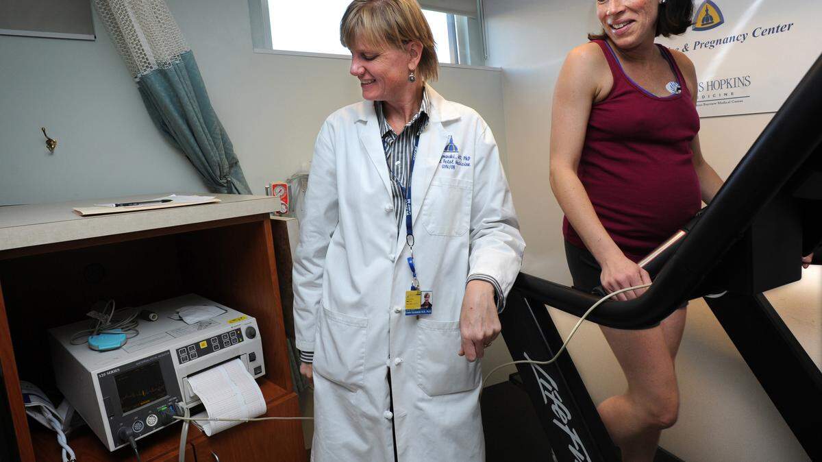 Meredith Dobrosielski, 36, right, exercises on a treadmill in Dr. Andrew Satin's lab as part of a health study about pregnant women and the effects of exercise, November 1, 2010, in Baltimore, Maryland. Dobrosielski was an avid runner for several years and is now in her 31st week of pregnancy. Linds Szymanski, MD, maternal fetal dedicine fellow, at left, is running the tests for Dr. Satin. (Algerina Perna/Baltimore Sun/MCT)