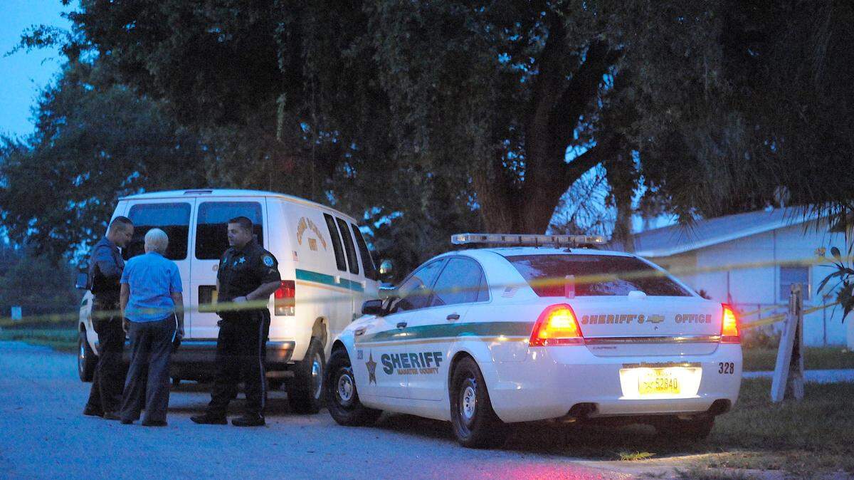 Police gather in the 6300 block of 11th St. St E in Bradenton outside the home where 45 year-old Tracy Hamilton was found deceased in her garage on Monday, Sept. 28, 2015. 
 PAUL VIDELA/Bradenton Herald