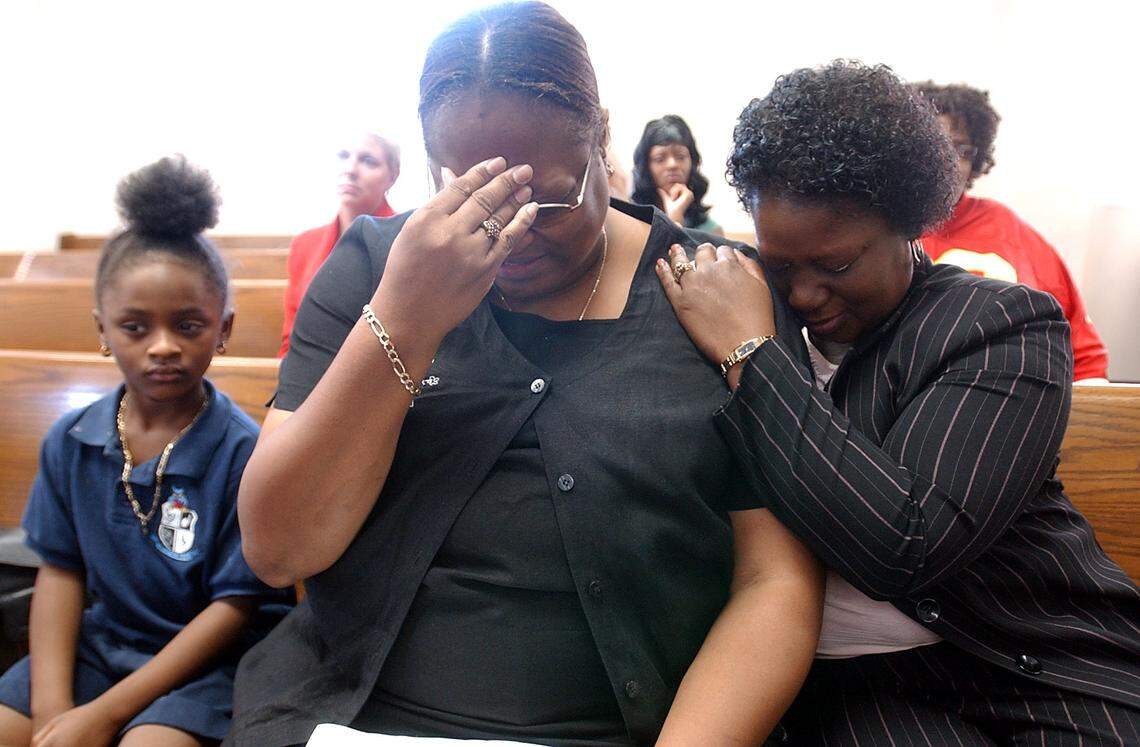 BRADENTON, 10/19/06--Laverne Joyner, center, is comforted by close friend, Debra Walker, at the sentencing for Javier Armando Martinez-Irias, who killed her son Dariel, and injured her other son, Jeremey, while he was driving drunk.--photo by Tiffany Tompkins-Condie/d