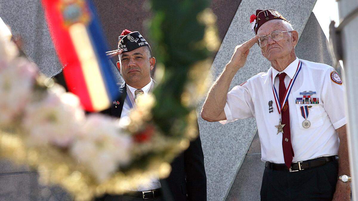 Retired Gy/Sgt. Greg Witham and Robert Eldridge salute during a Memorial Day service at the Veteran’s Monument in 2008.