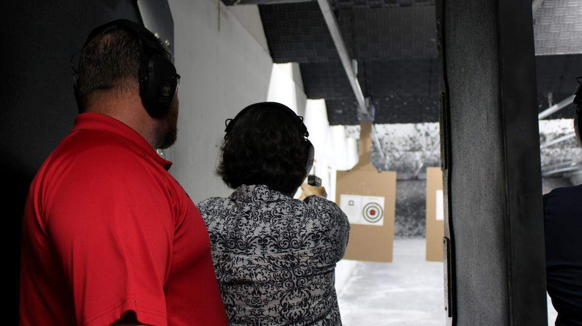Certified firearms instructor Detective Carl Jones works with student Jan Ludwig, in a 2024 Citizen Firearm Safety Class hosted by the Bradenton Police Department.