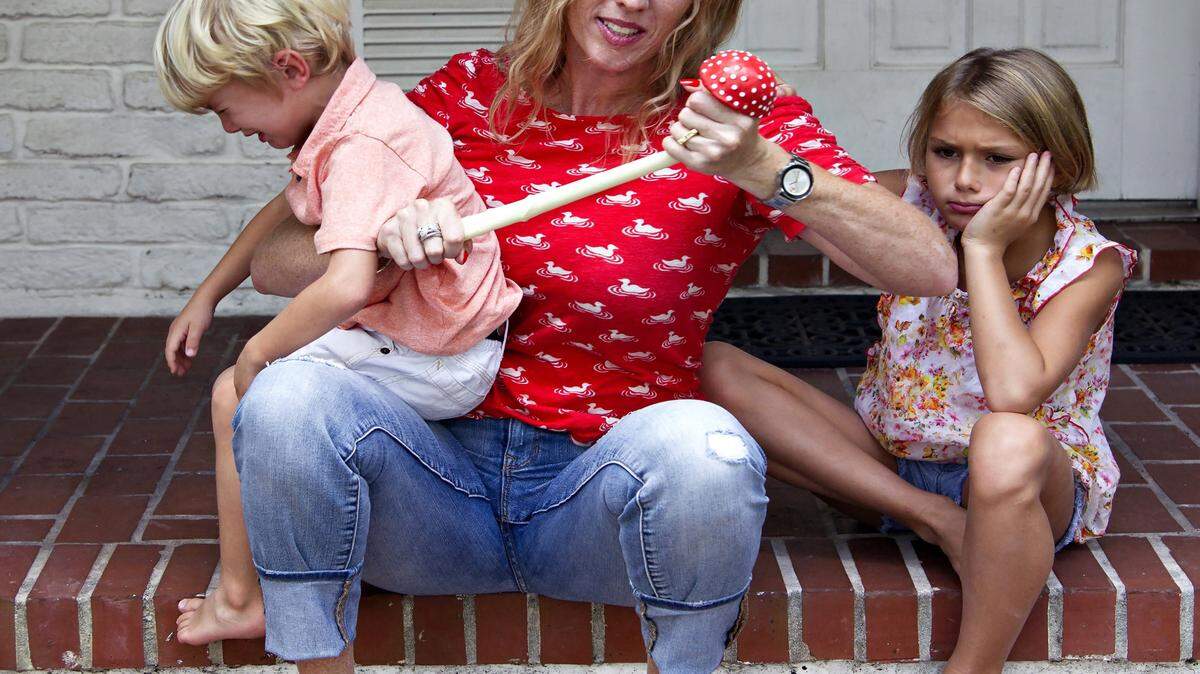 Stress Mushroom: Mother of two, Heathermarie Griffin, center, can find nirvana anywhere and anytime even when being pushed to the limit by her lovely children - Madelaine Griffin, 9, left, and Paxton Griffin - with the use of the "Stress Mushroom." Great way to relax without hallucinations. (Carl Juste/Miami Herald/TNS)