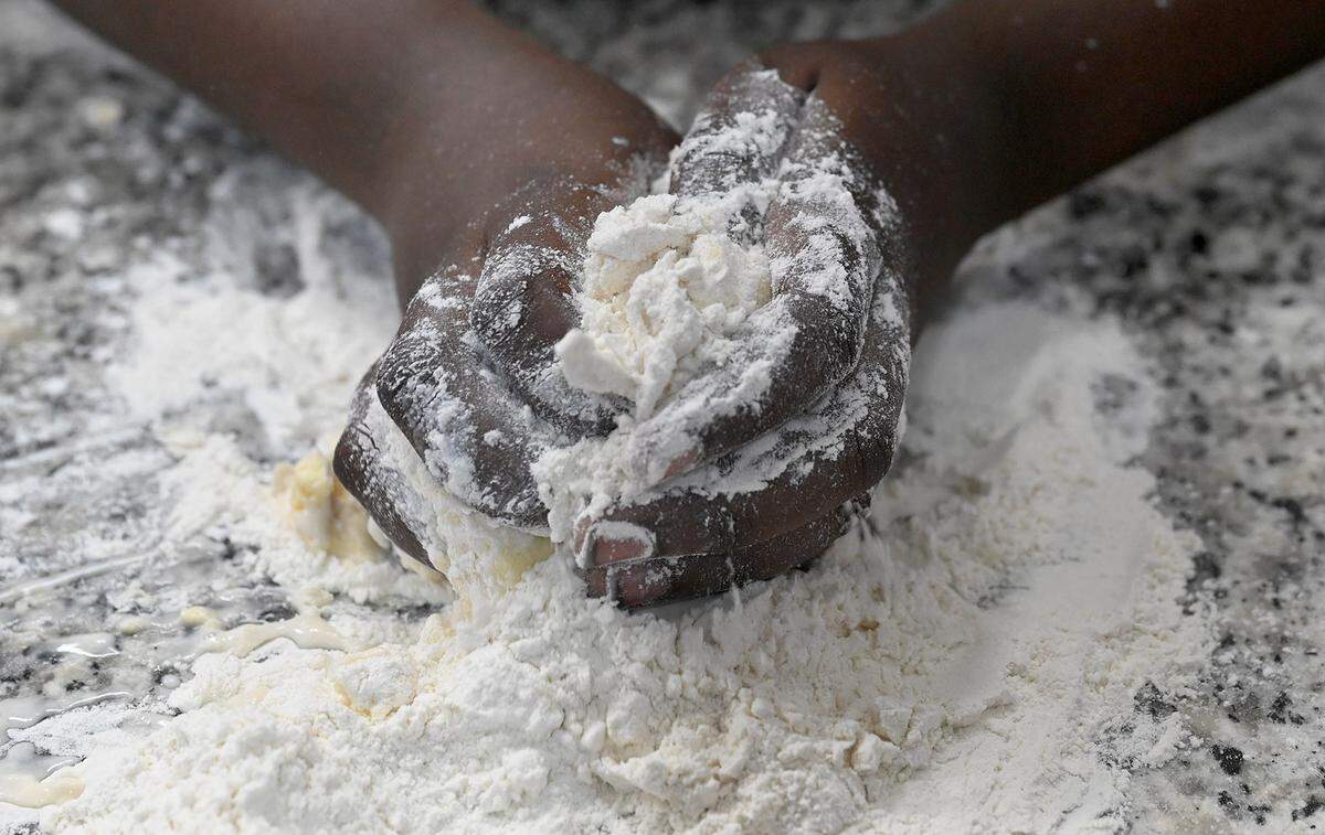 5th-grade student Feinley Louidor mixes Crisco and flour for a pie crust.
