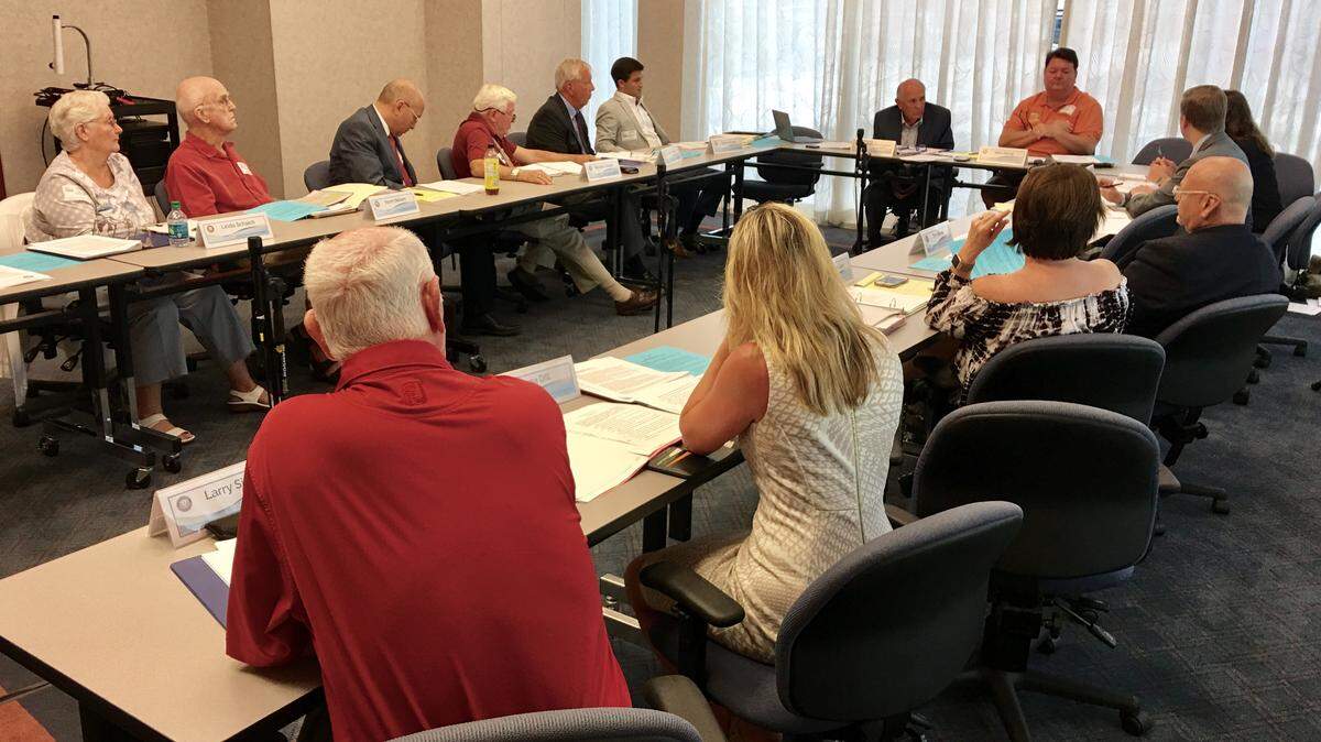 Fourteen members of the Citizens’ Financial Advisory Committee discuss future steps at its June 19 meeting.