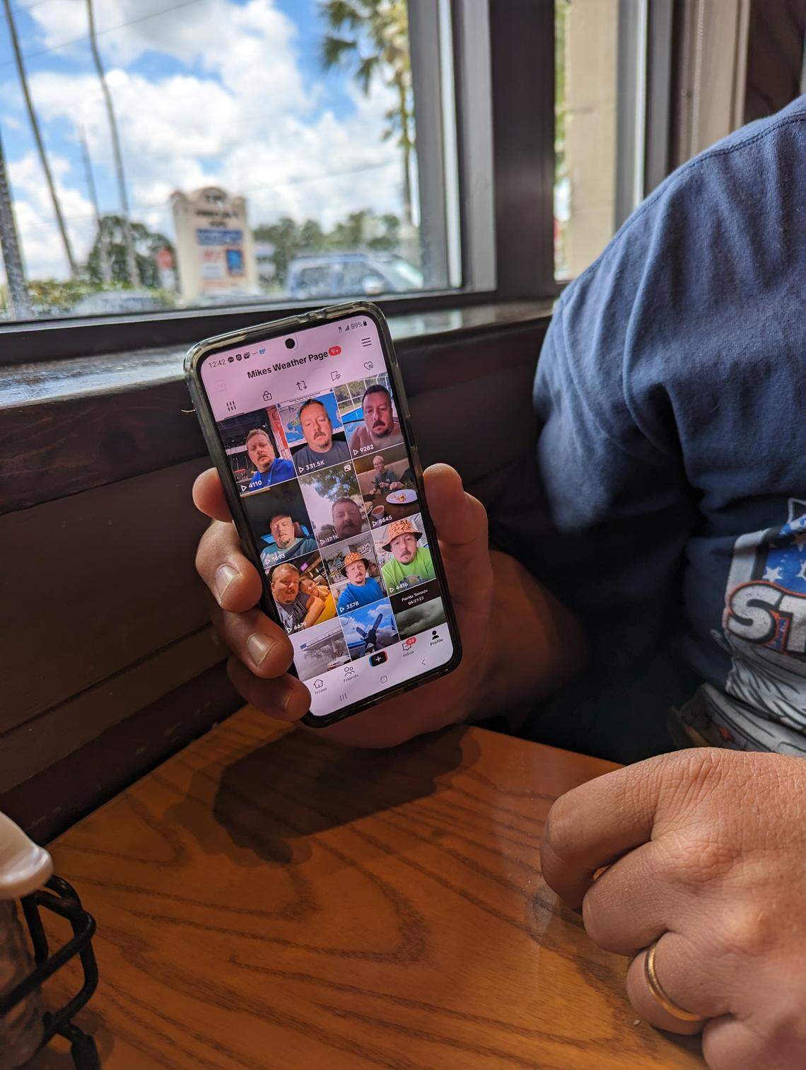 Mike Boylan of Mike’s Weather Page shows off his TikTok page at a Chili’s in Oldsmar, Florida. Boylan is prepping for tracking and chasing storms this hurricane season.
